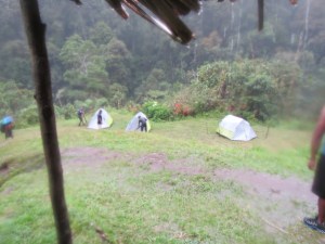 The boys putting up the tents in the rain